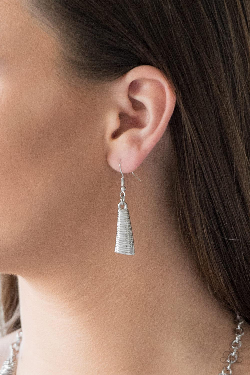 Paparazzi Accessories Feast or Famine - Silver Etched in linear patterns, dramatic silver plates connect below the collar, joining into a fierce crescent-shaped pendant for a statement making look. Features an adjustable clasp closure. Sold as one individ