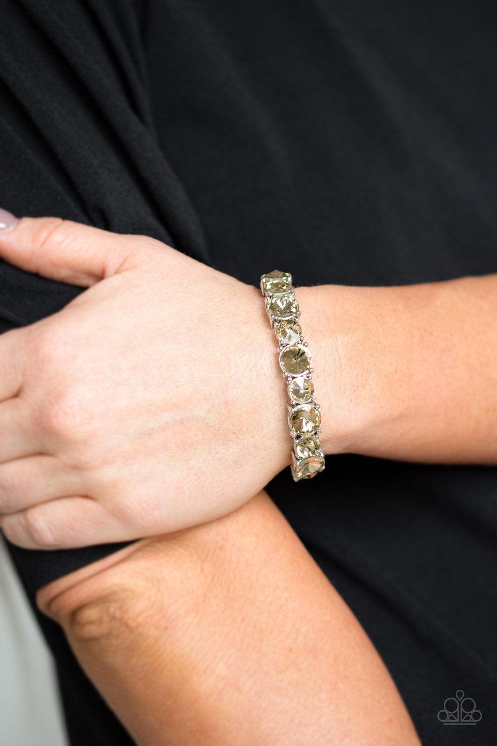 Paparazzi Accessories Born To Bedazzle - Brown An assortment of oversized golden topaz rhinestones are pressed into sleek square frames and threaded along stretchy bands, creating a blinding sparkle around the wrist. Jewelry