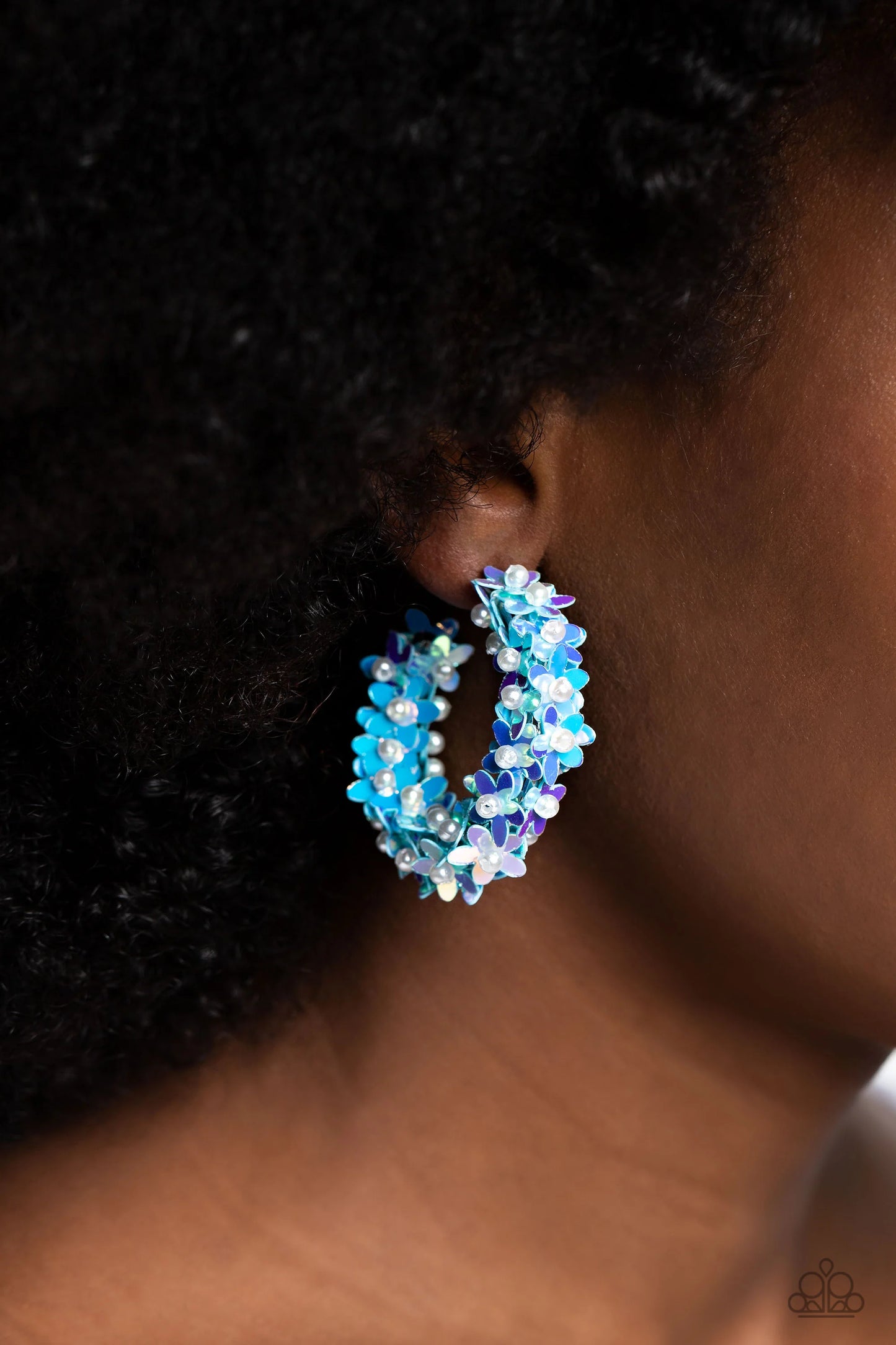 Paparazzi Accessories Fairy Fantasia - Blue A floral explosion, encompassing the entirety of a thick silver hoop, features reflective light blue flowers dotted with dainty pearl centers for a dreamy, whimsicality below the ear. Earring attaches to a stand