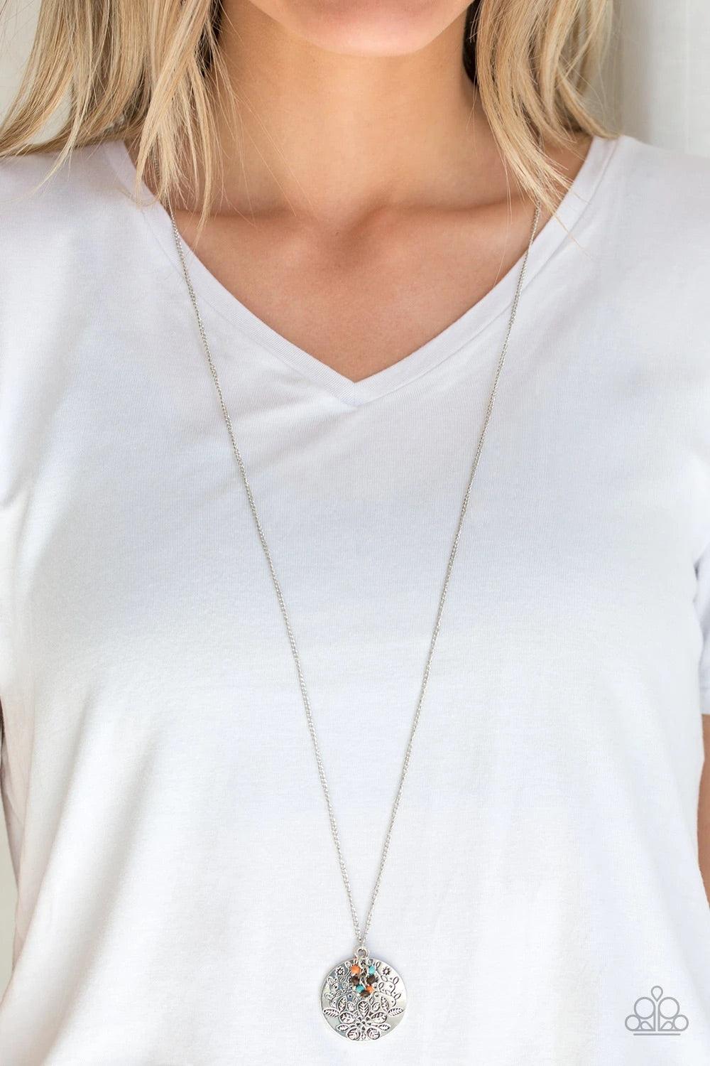 Paparazzi Accessories Desert Abundance - Multi A floral embossed silver disc and dainty wooden and multicolored stone beads swing from the bottom of a lengthened silver chain for whimsical look. Features an adjustable clasp closure. Sold as one individual