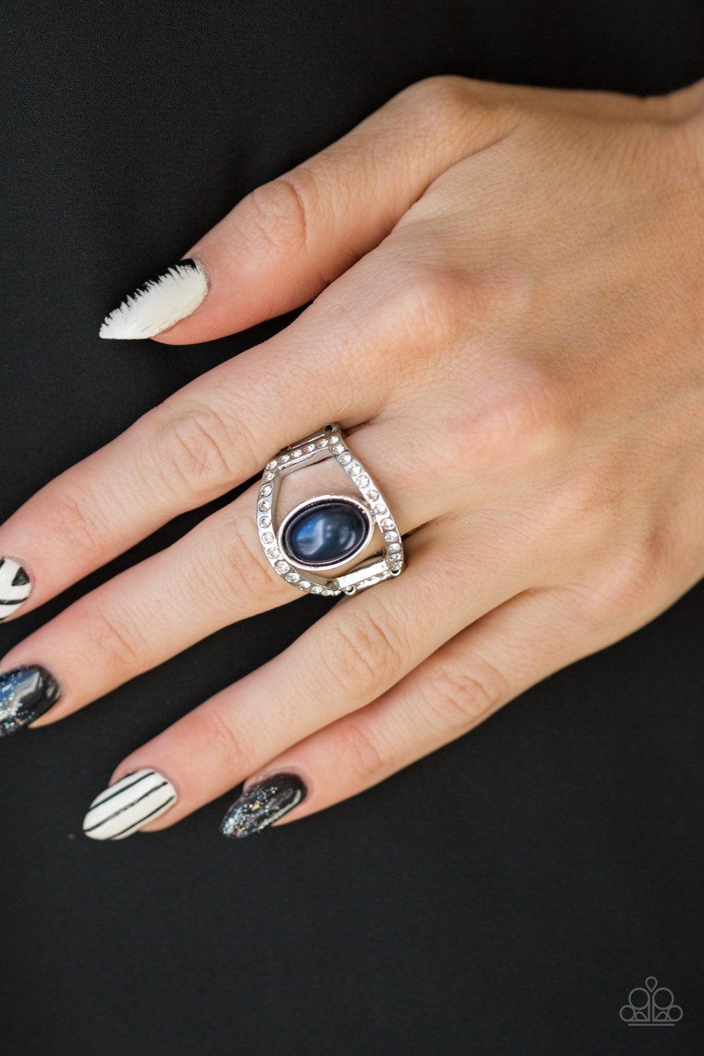 Paparazzi Accessories Radiating Riches - Blue A pearly blue bead sits between two white rhinestone encrusted bands, creating the illusion of a floating centerpiece. Features a stretchy band for a flexible fit. Jewelry