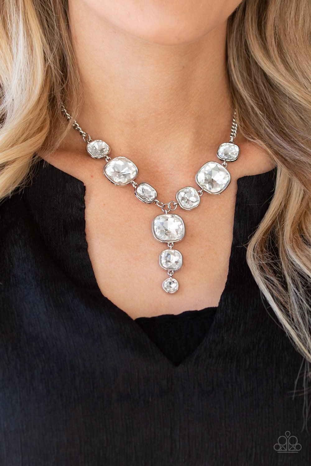 Paparazzi Accessories Legendary Luster - White Featuring sleek silver frames, a dramatic collection of white gems cascade from the bottom thick silver chain. Additional gems trickle from the center, creating a glamorous extended pendant below the collar.