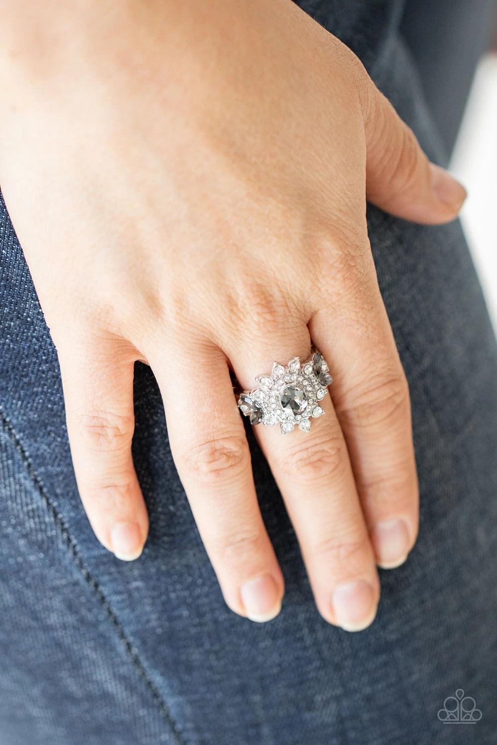Paparazzi Accessories The Princess and the FROND - Silver Glassy white rhinestone petals flare out from an oval smoky rhinestone center. Dainty smoky marquise rhinestones embellish the sides of the glittery frame, adding regal leafy accents. Features a st