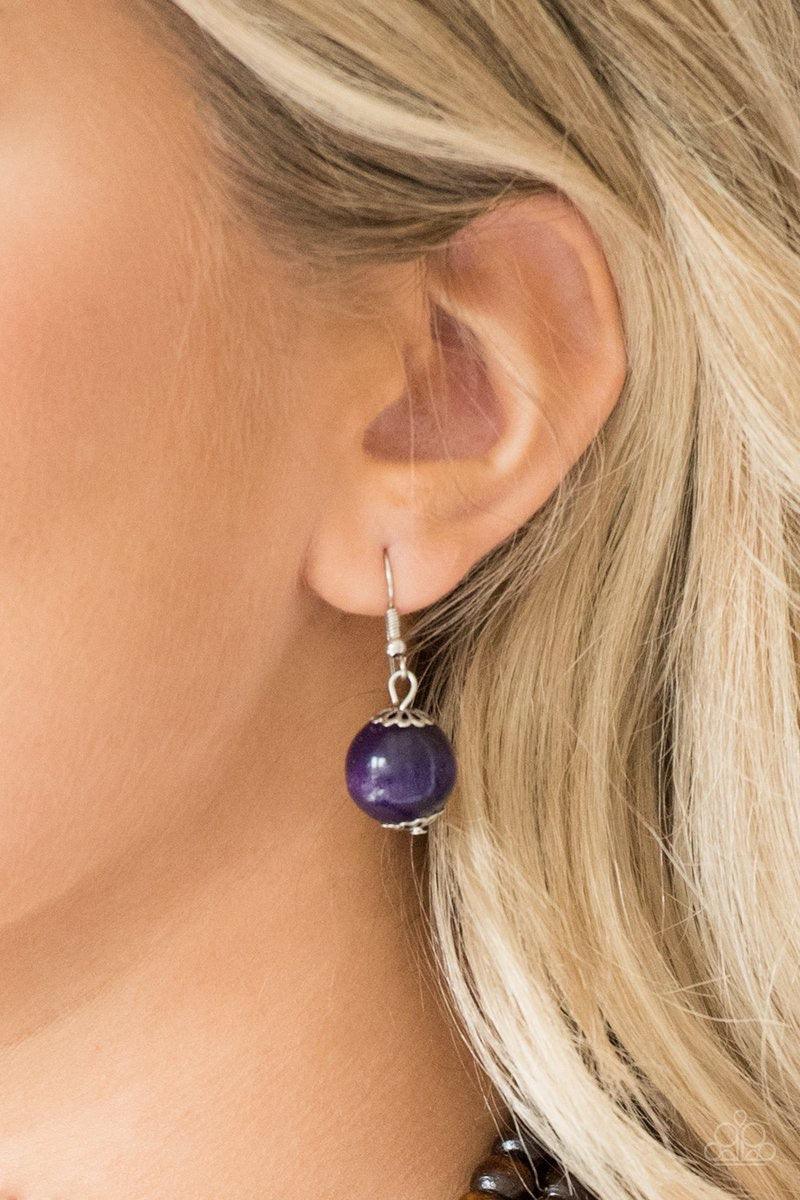 Paparazzi Accessories Cancun Cast Away - Purple Earthy brown and vivacious purple wooden beads and discs are threaded along shiny strands of brown cording, creating colorful layers. Features a button loop closure. Jewelry