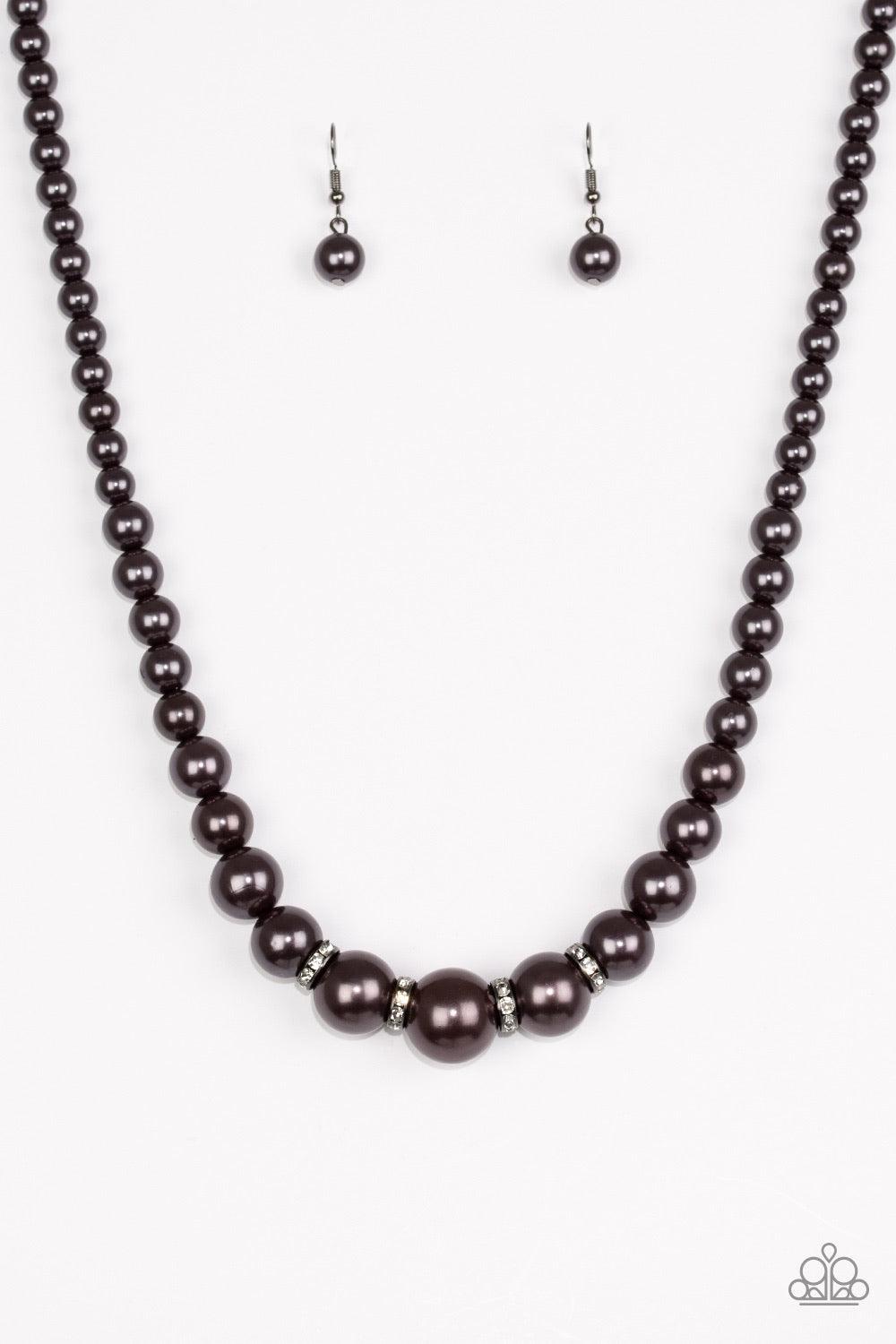 Paparazzi Accessories Party Pearls - Black Gradually increasing in size, pearly gunmetal beads trickle below the collar for a classic look. Encrusted in dazzling white rhinestones, glittery rings are sprinkled between the pearls for a timeless finish. Fea