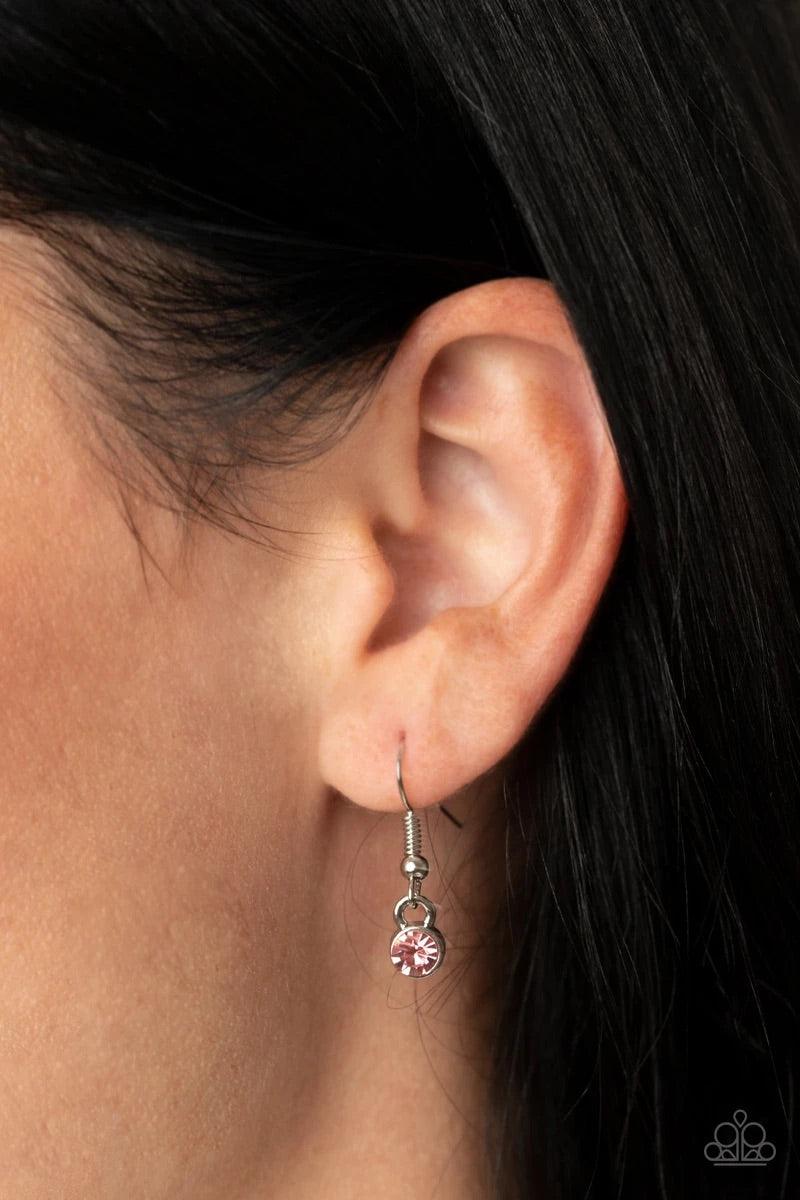 Paparazzi Accessories Subliminal Sparkle - Pink Encrusted in sections of glittery pink rhinestones, glistening silver bars swirl inside a pink rhinestone encrusted circle, creating a dizzying pendant at the bottom of a lengthened silver chain. Features an
