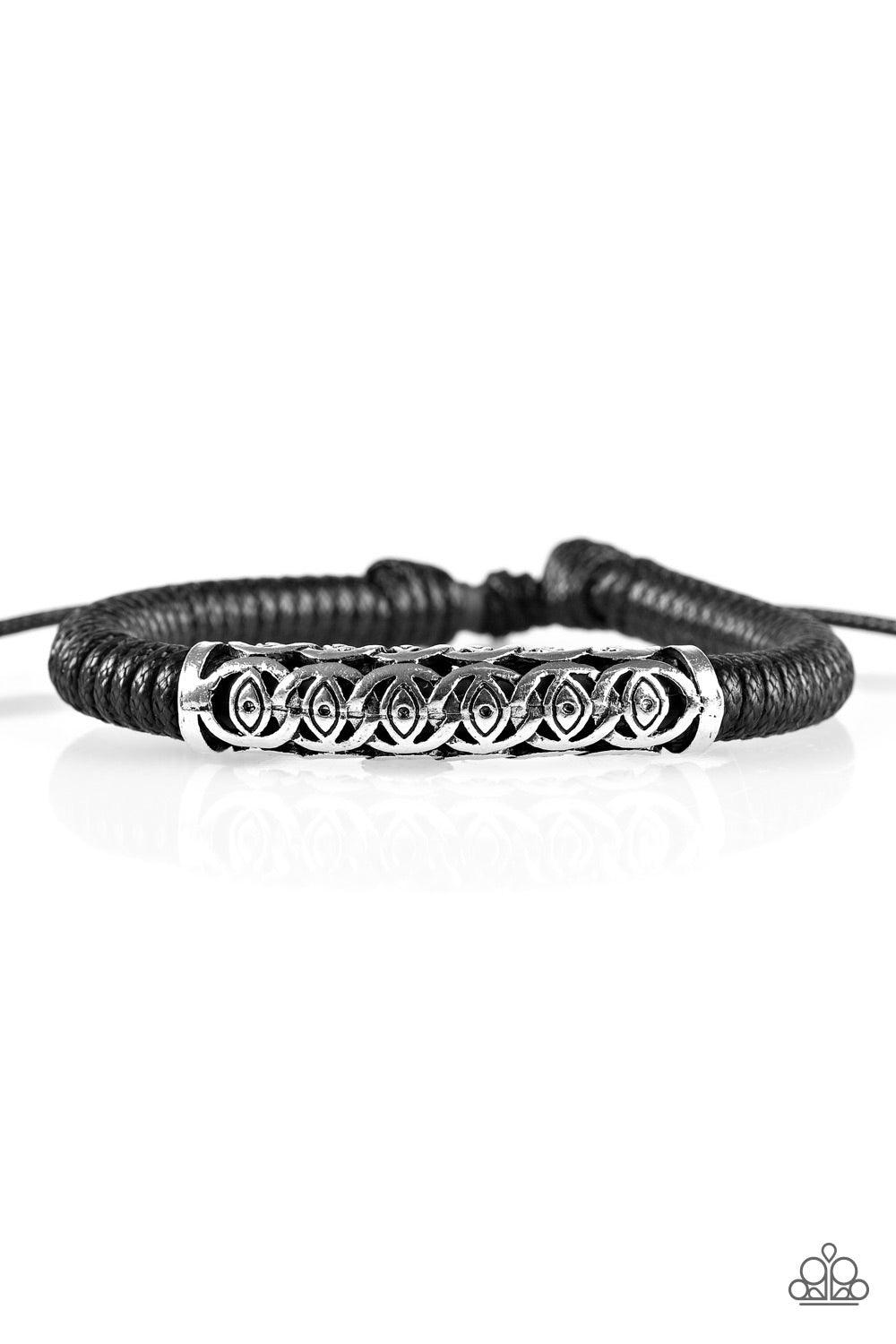 Paparazzi Accessories Island Escape - Black Black cording knots around a leather cord, creating a sleek urban piece around the wrist. An ornate silver bead slides along the colorful strand, creating a bold centerpiece. Features an adjustable sliding knot