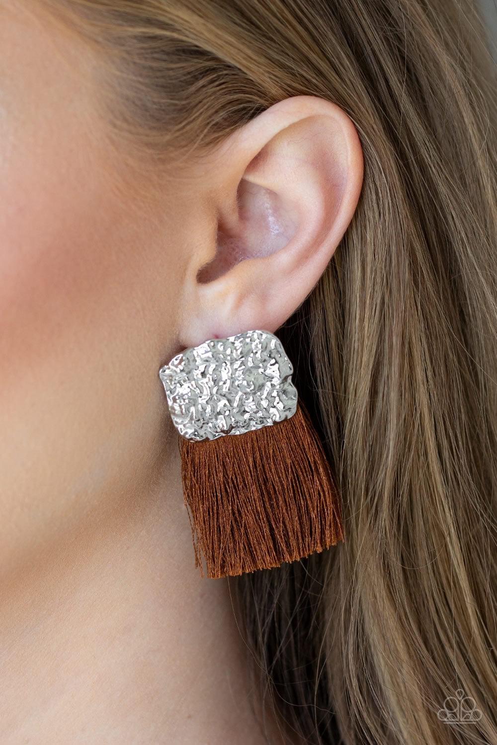 Paparazzi Accessories Plume Bloom - Brown A plume of shiny brown thread streams from the bottom of a hammered silver frame, creating a bold tasseled look. Earring attaches to a standard post fitting. Jewelry