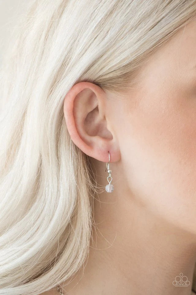 Paparazzi Accessories Colorful Cadence - White Faceted silver and glassy white beads trickle along shimmery silver chains down the chest for a whimsical look. Features an adjustable clasp closure. Jewelry