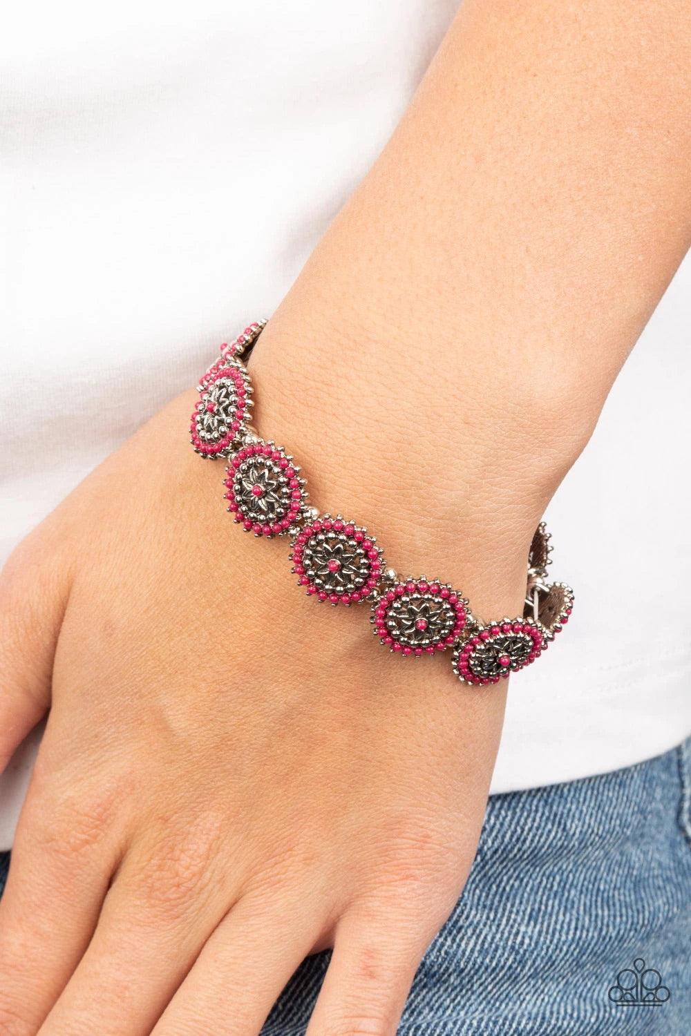 Paparazzi Accessories Bohemian Flowerbed - Pink Dotted in dainty Pink Peacock beads, studded silver floral frames are delicately threaded along stretchy bands around the wrist for a whimsically seasonal look. Sold as one individual bracelet. Jewelry