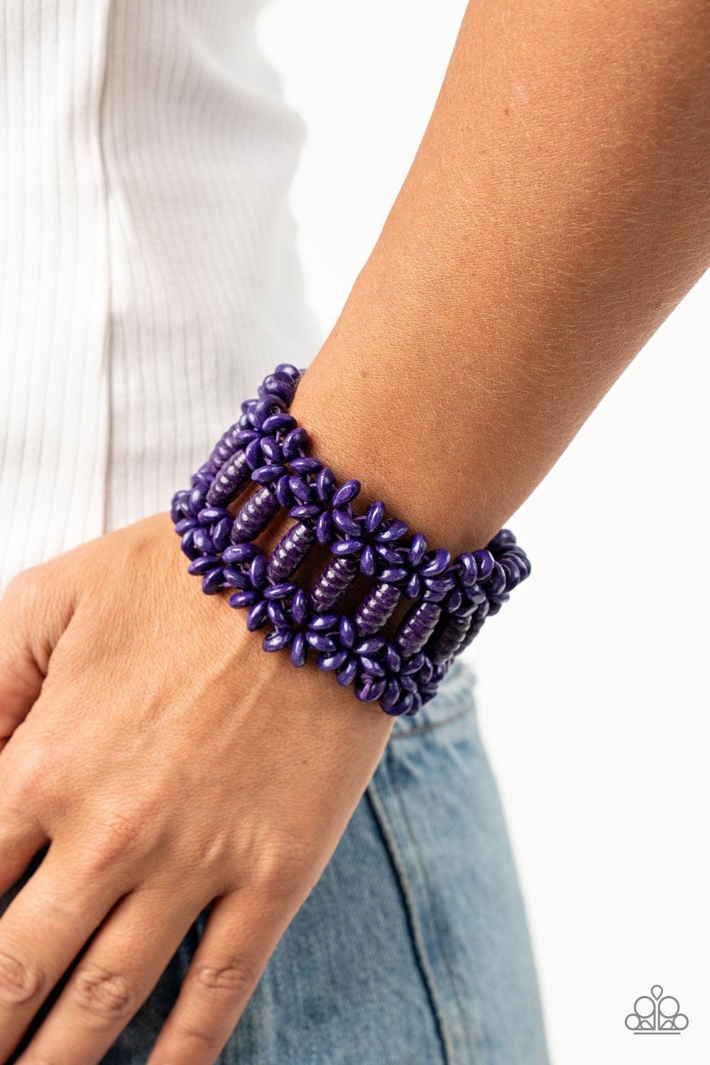 Paparazzi Accessories Fiji Flavor - Purple Painted in a vivacious purple finish, round and oval wooden beads are threaded along stretchy bands that weave into a colorful floral patterned stretch bracelet around the wrist. Sold as one individual bracelet.