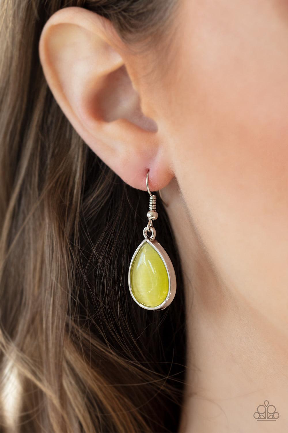 Paparazzi Accessories Dewy Decadence - Yellow A series of yellow cat's eye teardrops interlock at the bottom of a silver chain, giving way to an oversized teardrop pendant for a refined finish. Features an adjustable clasp closure. Jewelry