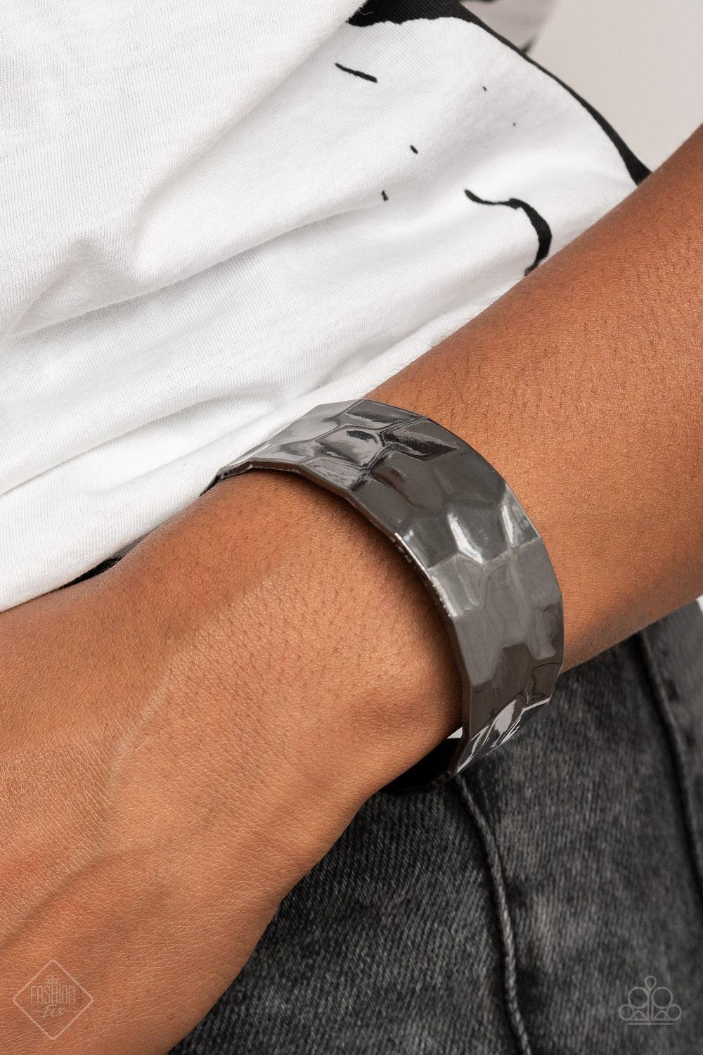 Paparazzi Accessories Is It HAUTE In Here? - Black A shimmery gunmetal cuff hammered in texture wraps around the wrist for a bold pop of industrial inspiration. Sold as one individual bracelet. Jewelry