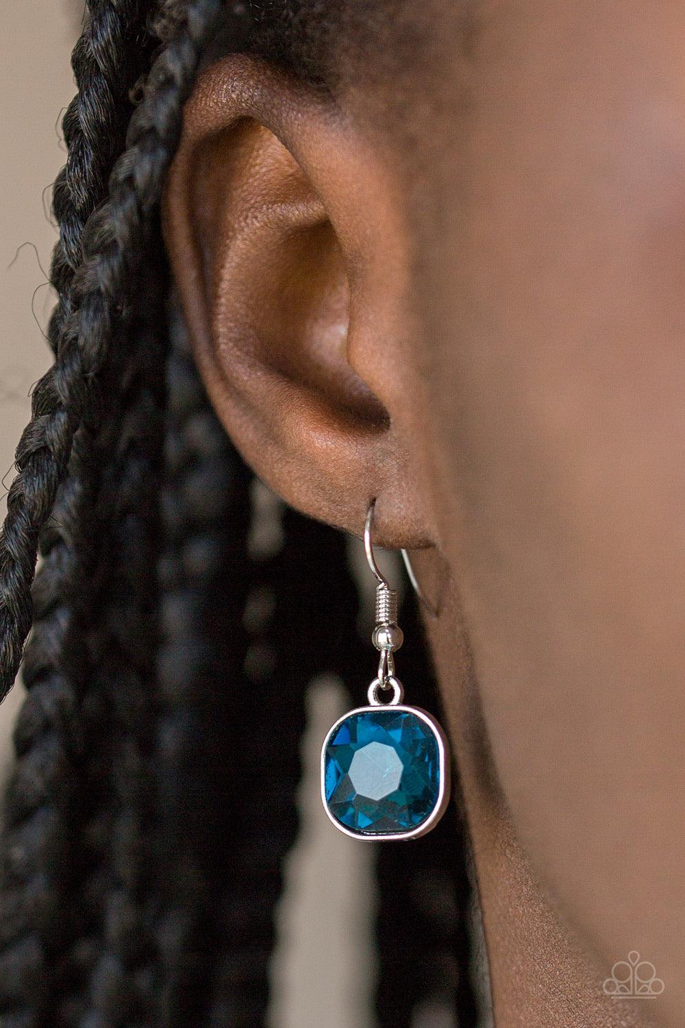 Paparazzi Accessories Dynamite Dazzle - Blue Pressed into a sleek silver frame, a dramatic blue gem swings from the bottom of a glistening silver chain below the collar for a chic look. Features a toggle closure. Jewelry