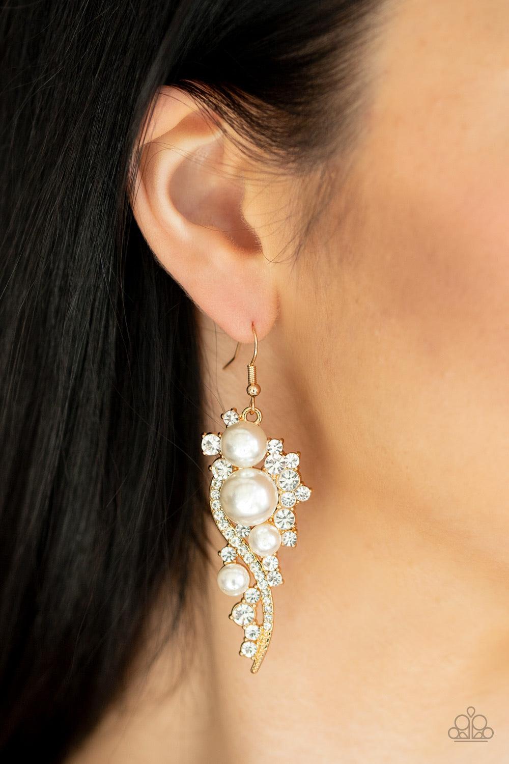 Paparazzi Accessories High-End Elegance - Gold Bubbly white pearls dot a glistening gold frame interwoven with ribbons of glittery white rhinestones, creating an elegant lure. Earring attaches to a standard fishhook fitting. Jewelry