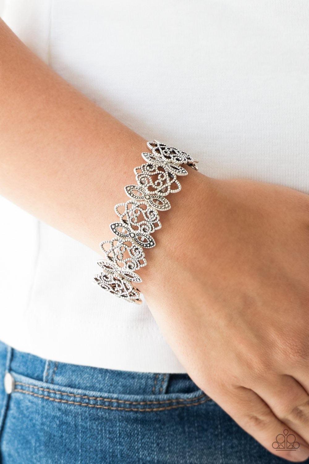 Paparazzi Accessories When Yin Met Yang - Silver Radiating with studded detail, ornate silver filigree frames are threaded along stretchy bands around the wrist for a whimsical look.Sold as one individual bracelet. Jewelry
