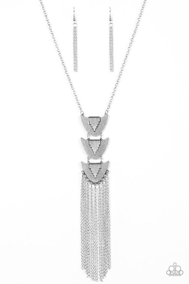 Paparazzi Accessories Paradise Prowess - Silver Radiating in linear textures, antiqued silver plates connect down the chest, creating a tribal inspired pendant. Glistening silver chains swing from the bottom of the stacked pendant, adding a whimsical tass