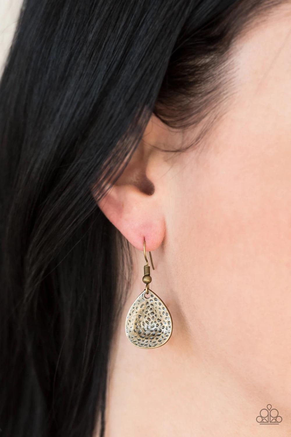 Paparazzi Accessories Storm Goddess - Brass Delicately hammered in light-catching shimmer, brass, copper, and silver teardrops drip from the bottom of a glistening brass chain, creating a bold fringe below the collar. Features an adjustable clasp closure.