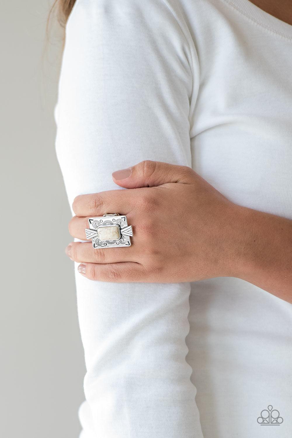 Paparazzi Accessories So Smithsonian - White Chiseled into a tranquil rectangle, a refreshing white stone is pressed into a bold silver frame radiating with tribal inspired patterns for a seasonal look. Features a stretchy band for a flexible fit. Sold as