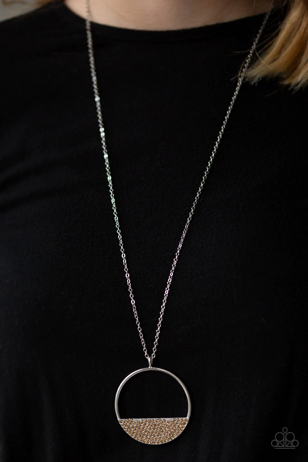 Paparazzi Accessories Bet Your Bottom Dollar - Brown Encrusted in golden topaz rhinestones, a silver crescent frame is pressed into the bottom of an airy circular pendant for a timeless look. Features an adjustable clasp closure. Sold as one individual ne