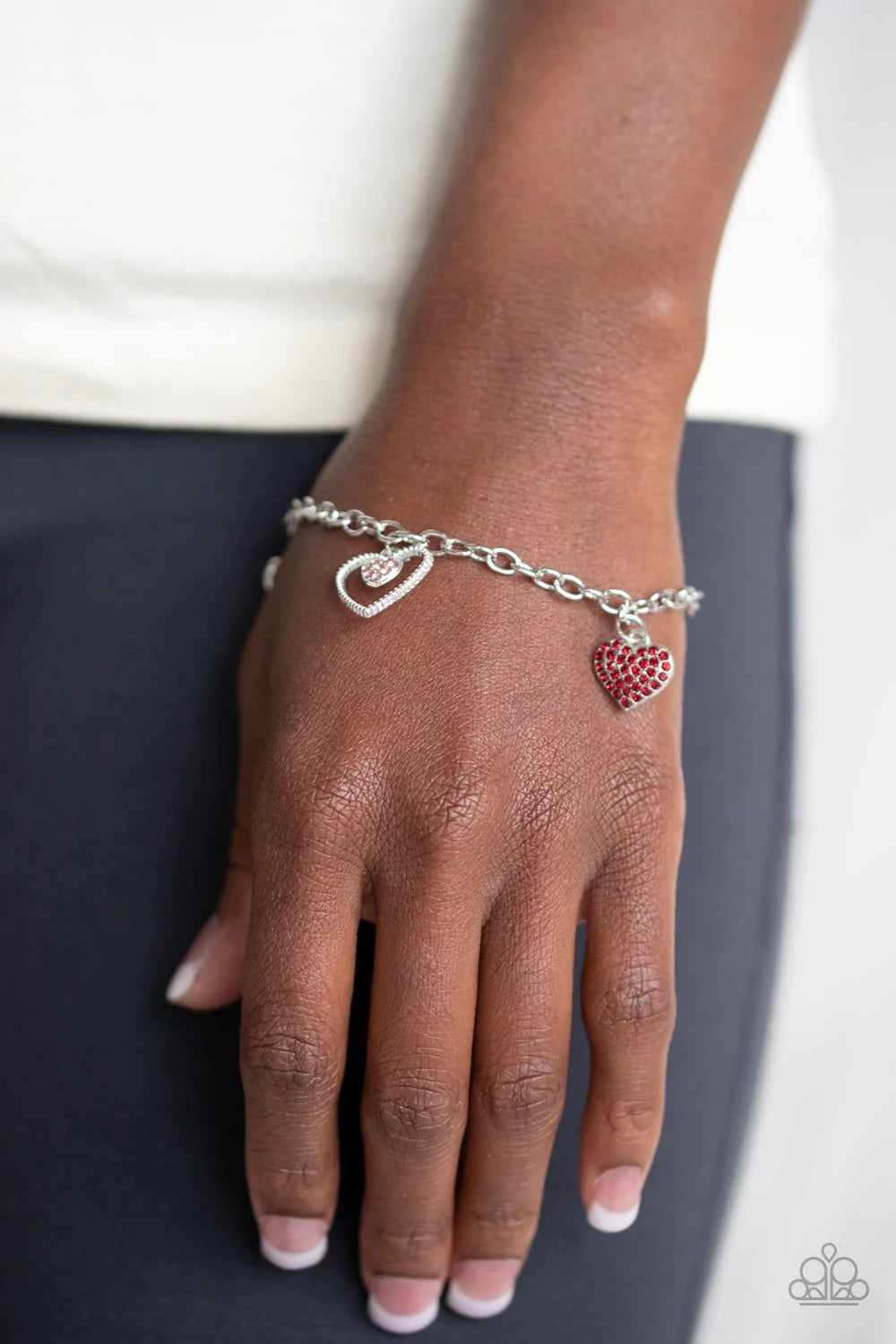Paparazzi Accessories Hearts And Harps - Multi A charming collection of red hearts and white rhinestone encrusted heart frames dangle from a glistening silver chain, creating a flirtatious fringe around the wrist. Features an adjustable clasp closure. Bra