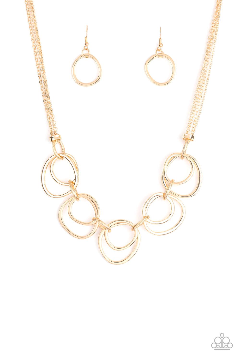 Paparazzi Accessories Asymmetrical Adornment - Gold Infused with decorative gold links, an asymmetrical assortment of gold rings delicately link below the collar for a refined flair. Features an adjustable clasp closure. Sold as one individual necklace. I
