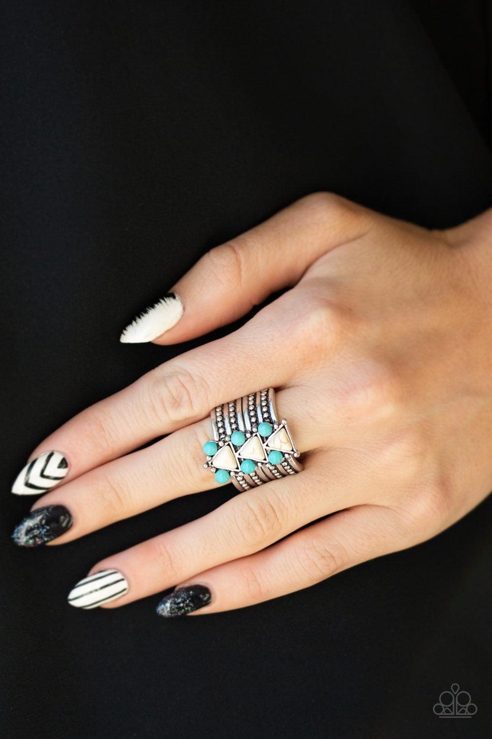 Paparazzi Accessories Point Me To Phoenix - Blue Round turquoise stones and white triangular stones are pressed down the center of a thick silver band radiating with studded silver textures for an indigenous look. Features a stretchy band for a flexible f
