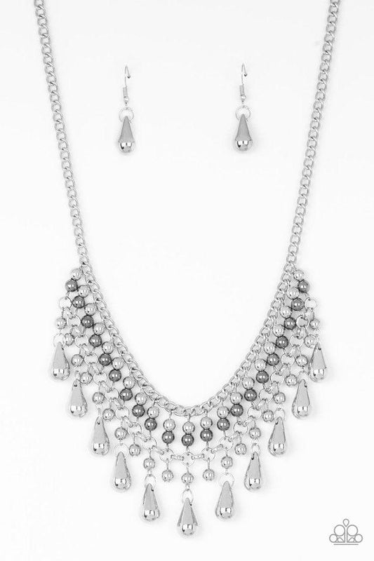 Paparazzi Accessories Don’t Forget To BOSS! - Silver Threaded along metallic rods, stacked silver and gunmetal beads give way to shimmery silver teardrops. The edgy fringe flawlessly drapes beneath the collar, creating a sassy tapered fringe. Features an