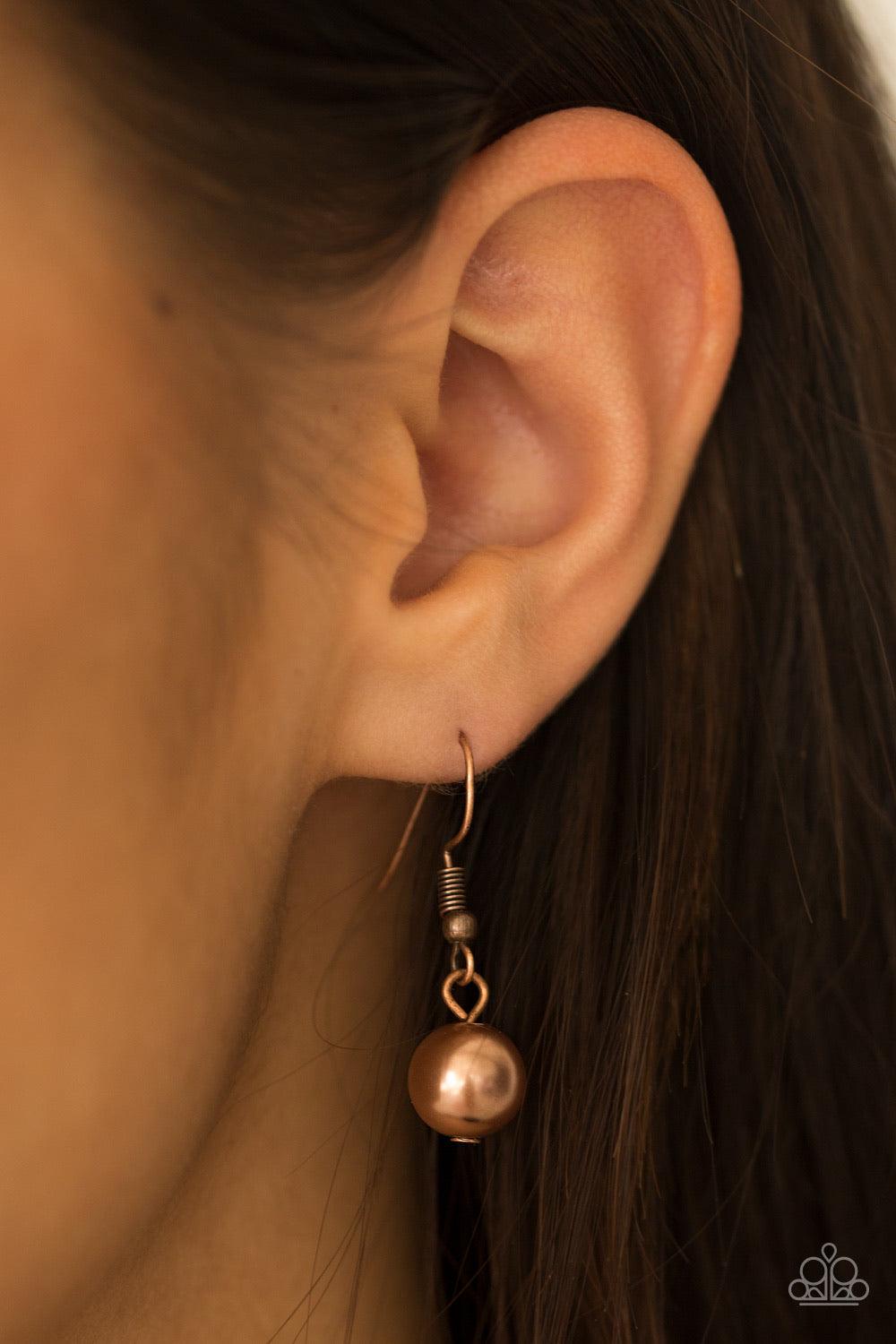 Paparazzi Accessories Catwalk Champ - Copper Varying in length, glistening copper chains swing from the bottom of a bold copper chain. Pearly copper beads trickle down the chains, creating a fierce fringe below the collar. Features an adjustable clasp clo