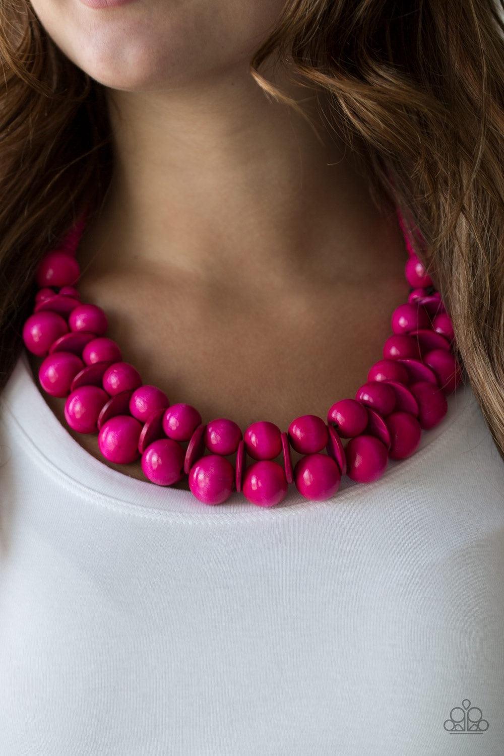 Paparazzi Accessories Caribbean Cover Girl - Pink Brushed in a distressed finish, vivacious pink wooden beads and discs join below the collar for a summery look. Features a button loop closure. Jewelry