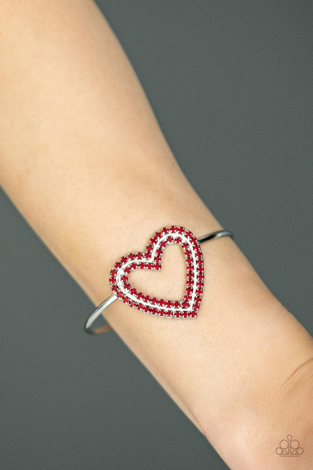 Paparazzi Accessories Heart Opener - Red Two rows of glittery red rhinestones stack into a sparkling heart atop a dainty silver cuff for a charming look. Jewelry