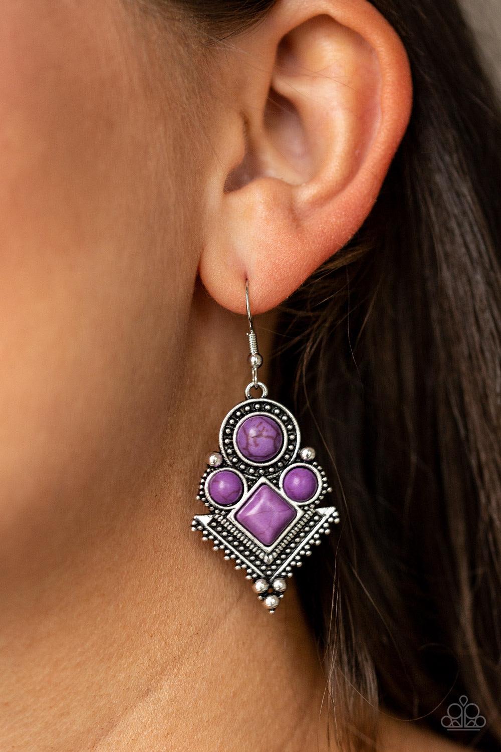 Paparazzi Accessories So Sonoran ~Purple Chiseled into round and square beads, vivacious purple stones are pressed into an ornate geometric frame radiating with shimmery silver studs for a tribal inspired look. Earring attaches to a standard fishhook fitt