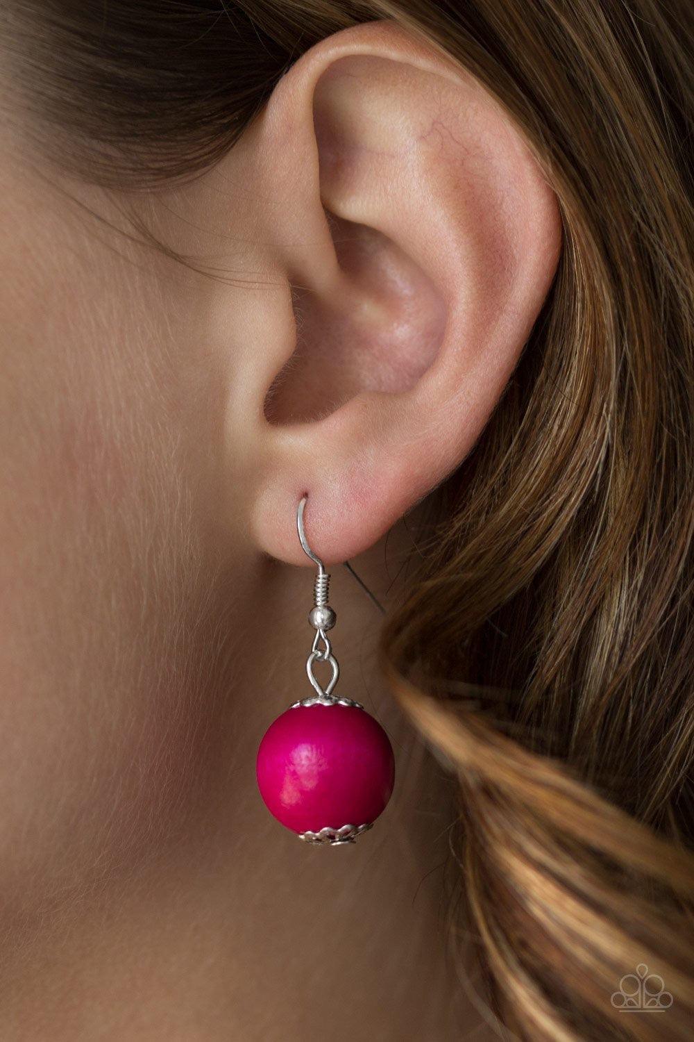 Paparazzi Accessories Caribbean Cover Girl - Pink Brushed in a distressed finish, vivacious pink wooden beads and discs join below the collar for a summery look. Features a button loop closure. Jewelry