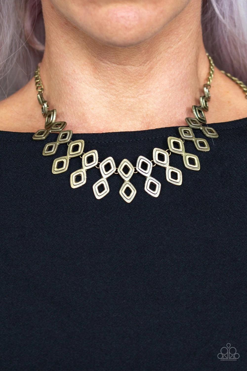 Paparazzi Accessories Geocentric - Brass Brushed in an antiqued shimmer, glistening diamond-shaped brass frames link below the collar, coalescing into an edgy geometric fringe. Features an adjustable clasp closure. Sold as one individual necklace. Include