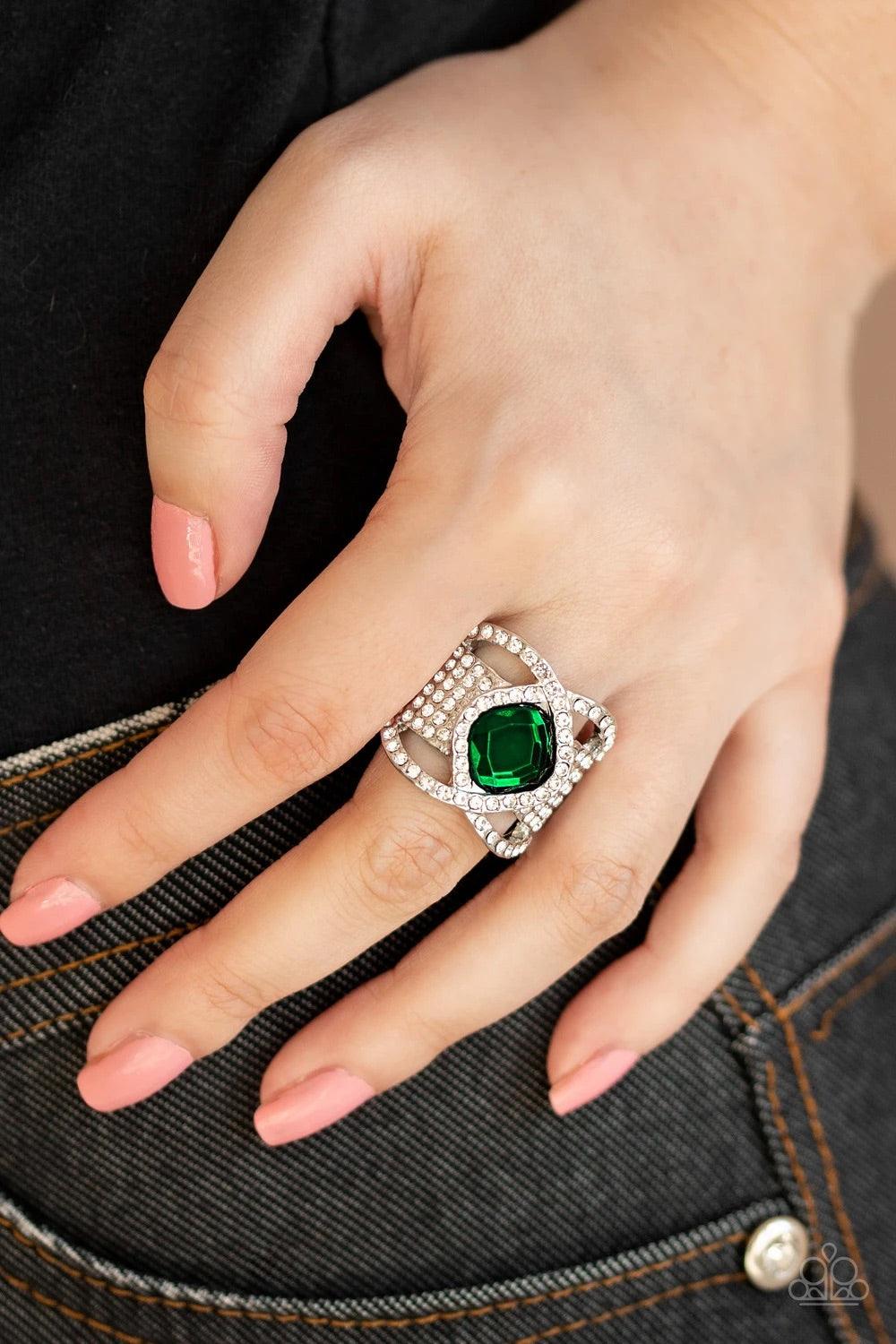 Paparazzi Accessories Triple Crown Twinkle ~Green Featuring a regal cut, a dramatic green rhinestone is nestled between interweaving white rhinestone encrusted bars atop a thick silver band stacked in row after row of white rhinestones for a statement-mak
