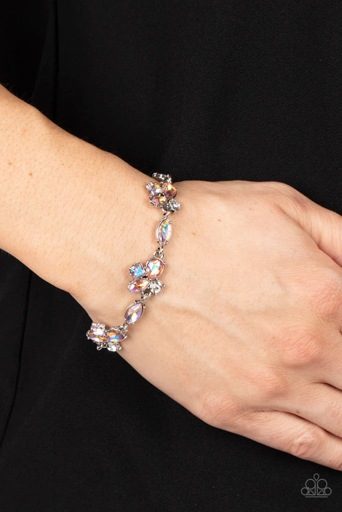 Paparazzi Accessories Colorful Captivation - Orange Featuring various cuts and finishes, dainty clusters of white, pink, and orange iridescent rhinestones delicately link with marquise cut rhinestones around the wrist for an effervescent elegance. Feature
