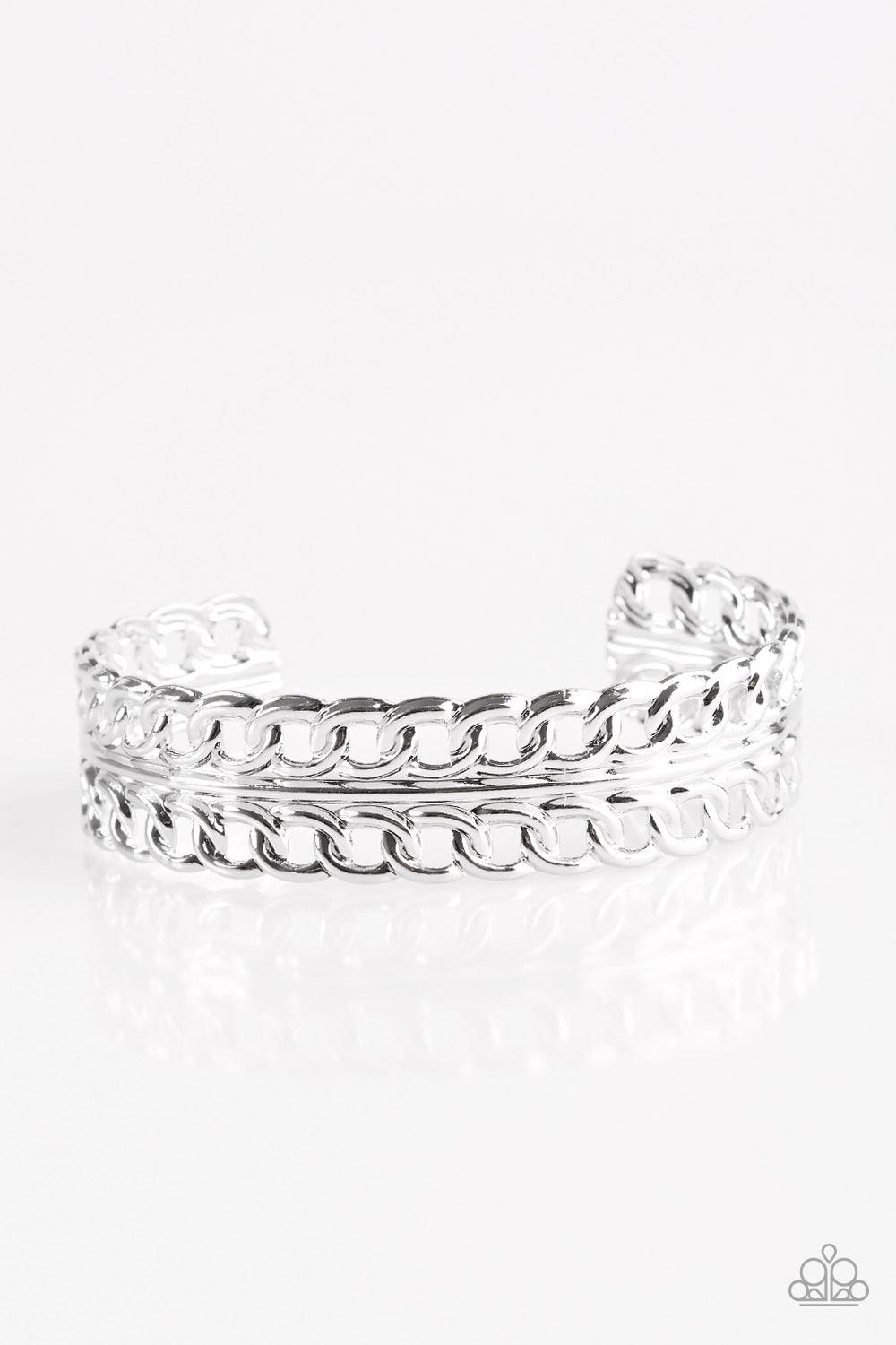 Paparazzi Accessories Progressive Movement - Silver Glistening rows of silver chain link stack across the wrist, coalescing into a bold industrial cuff. Jewelry