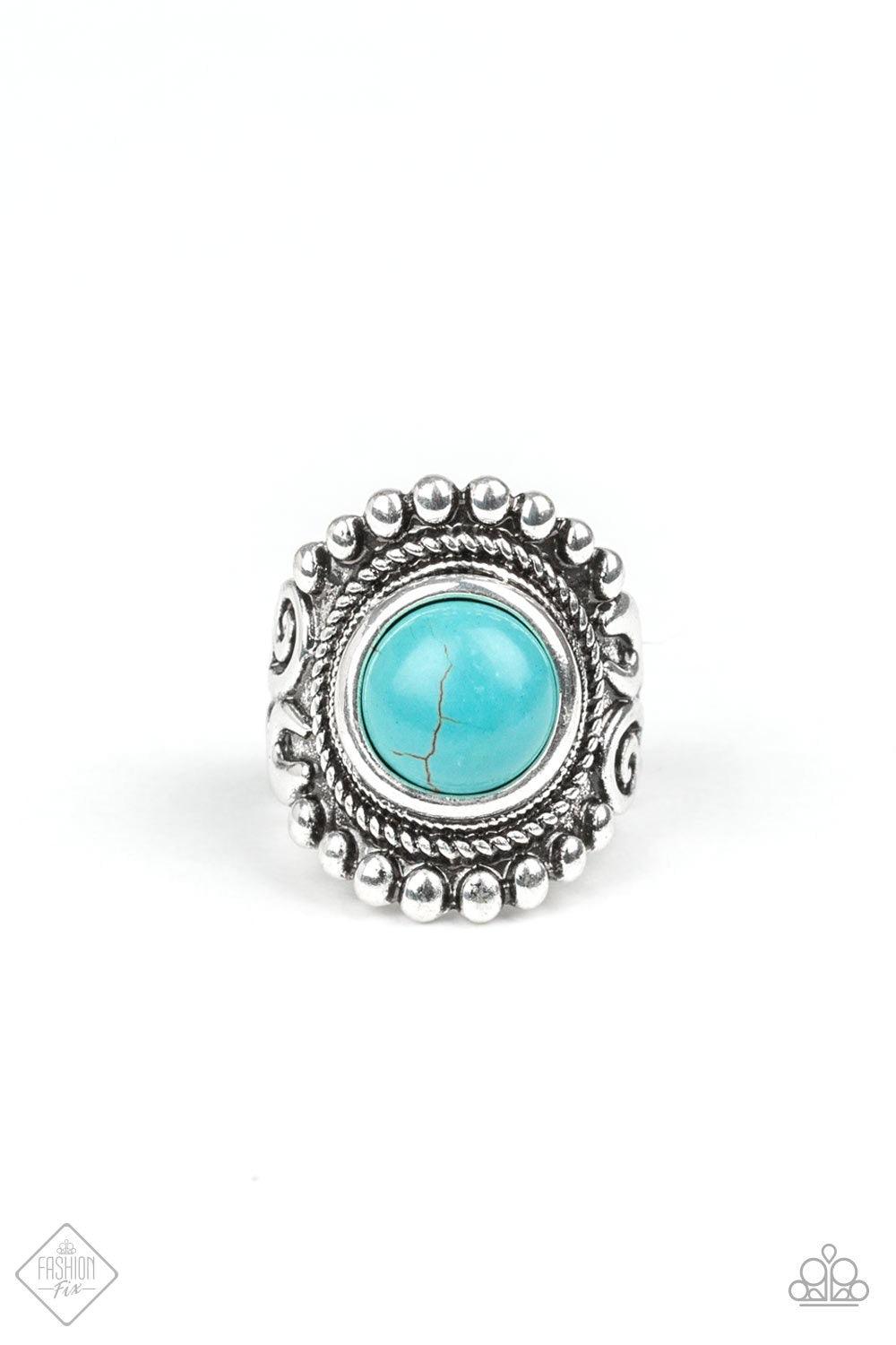 Paparazzi Accessories Nomad Drama - Blue A refreshing turquoise stone is pressed into the center of a round silver frame bordered by shiny silver studs for a rustic look. Features a stretchy band for a flexible fit. Jewelry