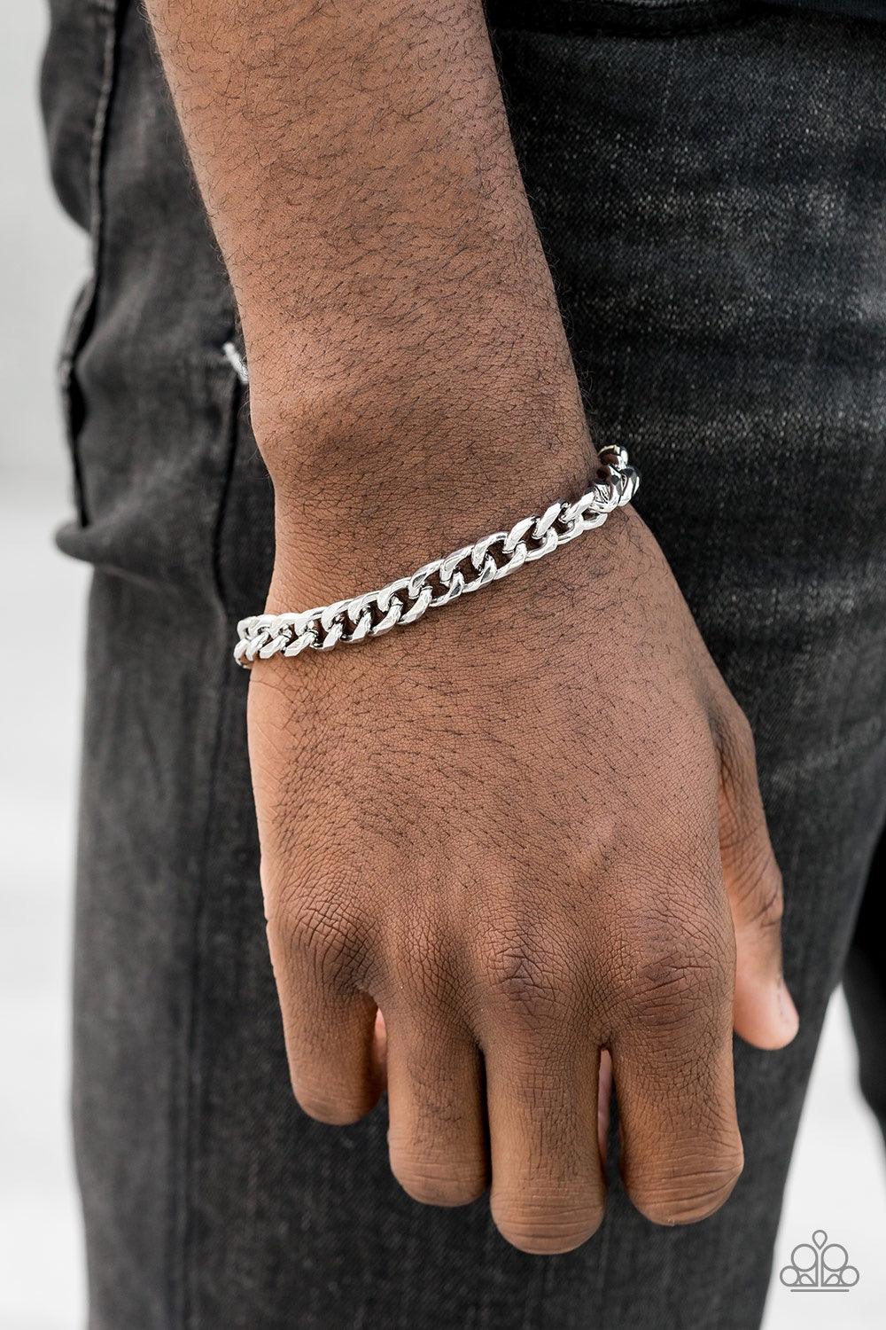 Paparazzi Accessories Take It To The Bank - White Featuring classic curb link chain, a thick silver chain wraps around the wrist for a sleek, metro look. Features an adjustable clasp closure. Jewelry