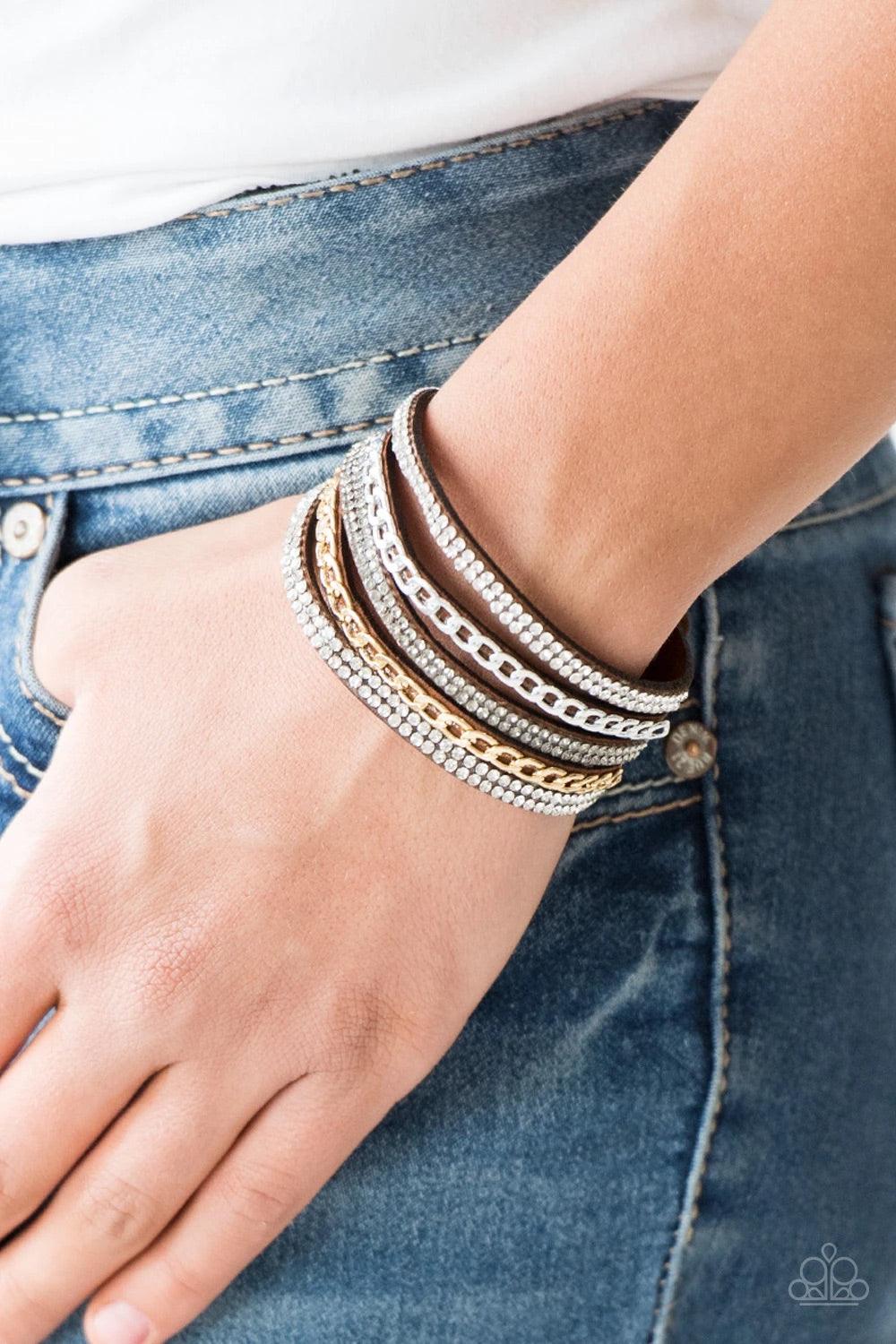 Paparazzi Accessories Fashion Fiend - Brown Glassy white and smoky rhinestones are encrusted along strands of brown suede. Glistening silver and gold chains are added to the bands, adding edgy industrial shimmer to the sassy palette. Features an adjustabl