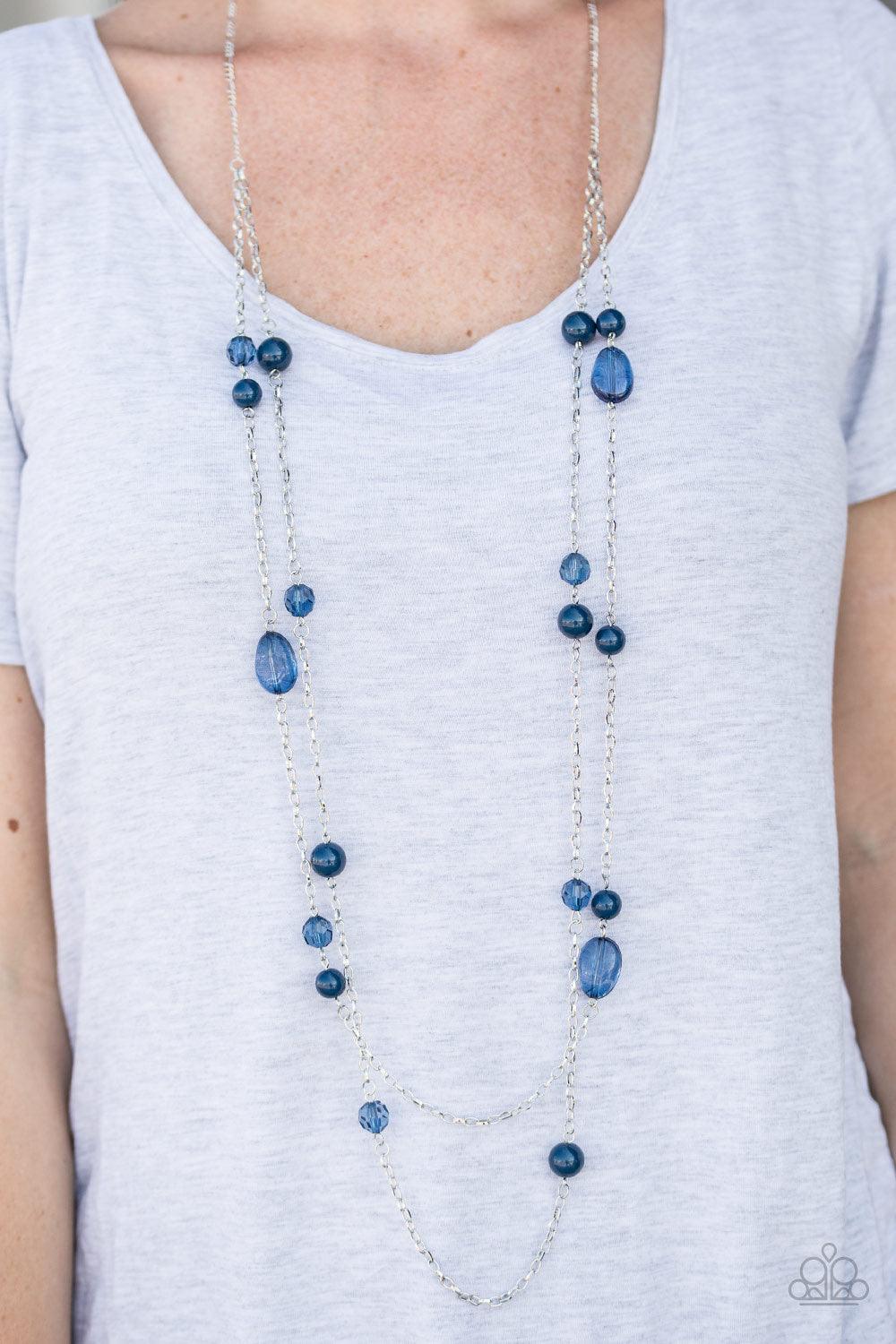 Paparazzi Accessories In Your Gleams - Blue Tinted in the refreshing shade of Navy Peony, polished, translucent, and crystal-like beads trickle along two shimmery silver chains for a whimsical look. Features an adjustable clasp closure. Sold as one indivi