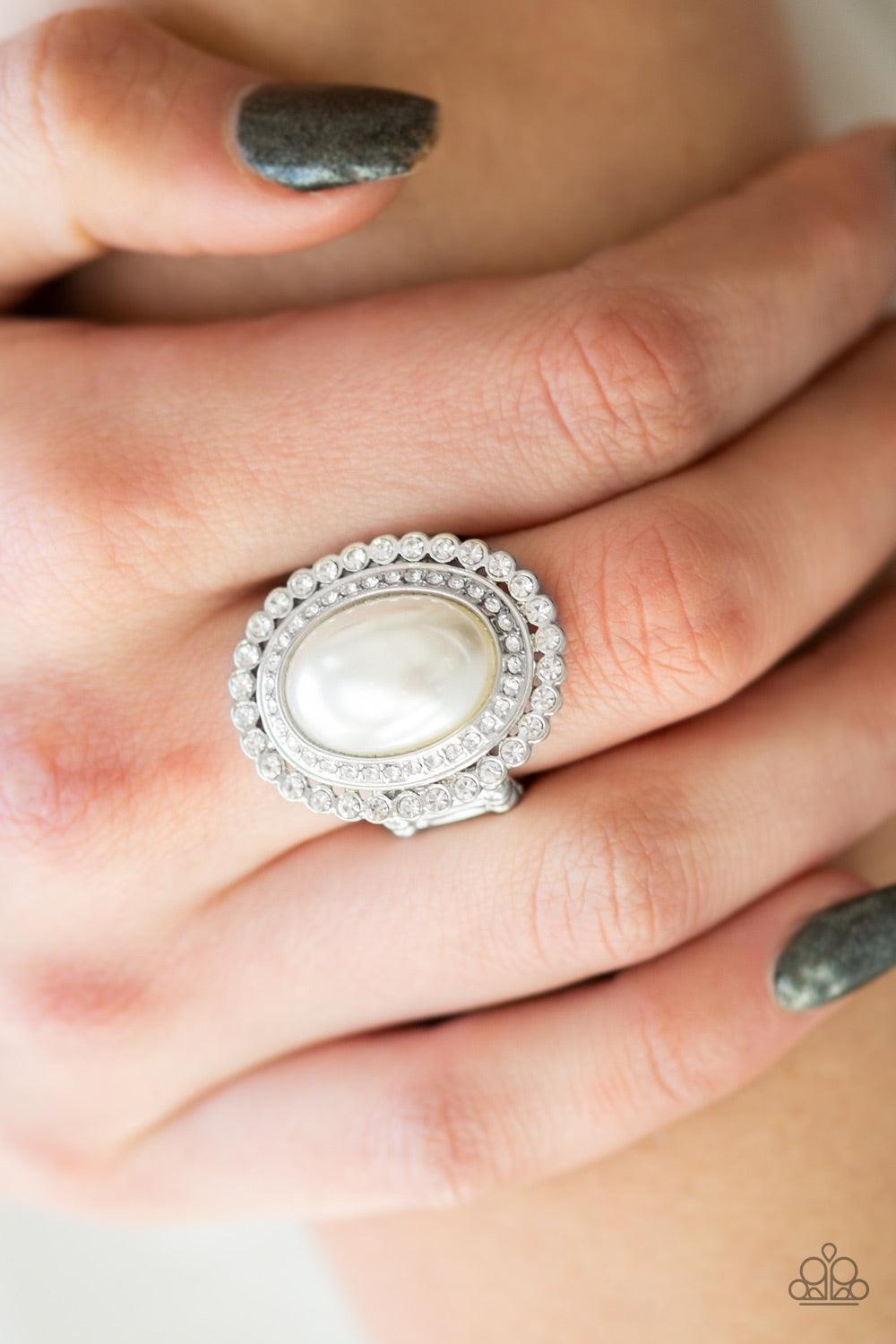 Paparazzi Accessories Opulently Olympic - White A pearly white bead adorns the center of stacked silver frames encrusted in glassy white rhinestones for a dramatically refined look. Features a stretchy band for a flexible fit. Jewelry