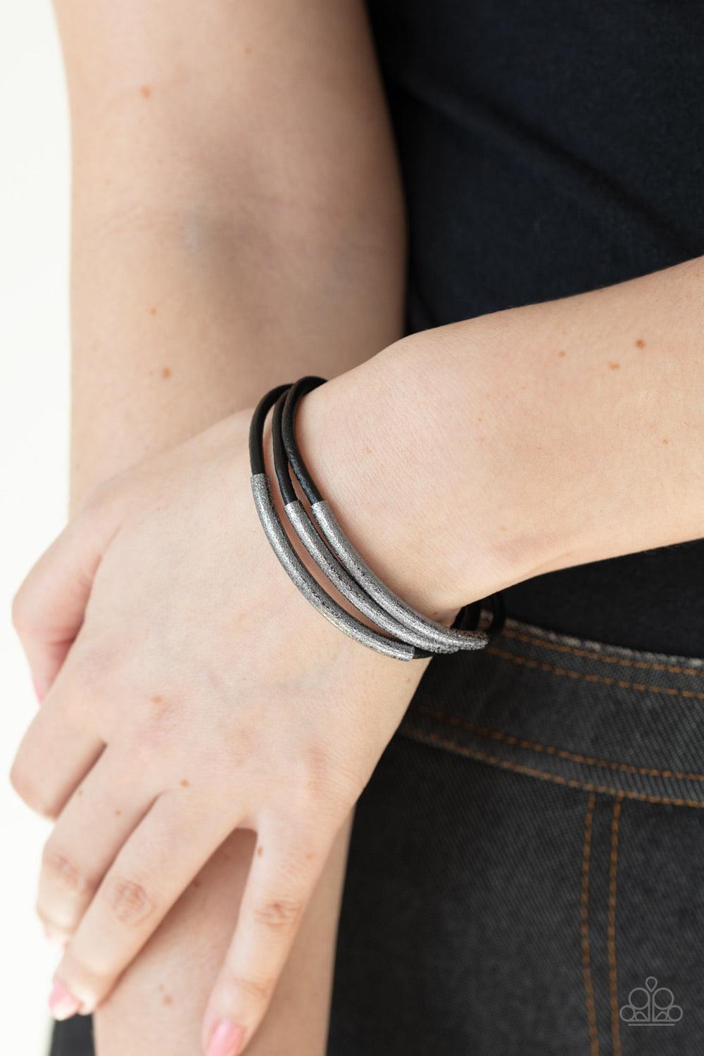 Paparazzi Accessories Magnetic Maverick - Black Hammered gunmetal accents are threaded along layers of black cording, creating an edgy centerpiece. Features a magnetic closure. Jewelry