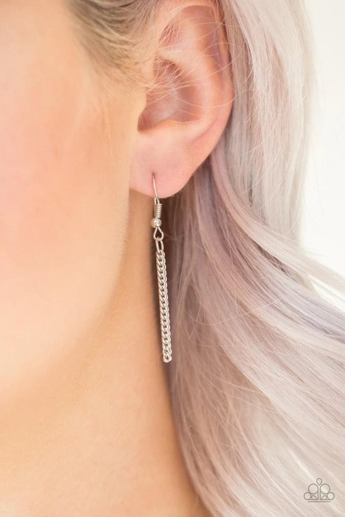 Paparazzi Accessories Triple Shimmer - Silver Sprinkled in smoky and hematite prism style rhinestones, three sparkling silver frames trickle down the chest. A shimmery silver tassel swings from the bottom of the triple stacked pendant for a glamorous fini