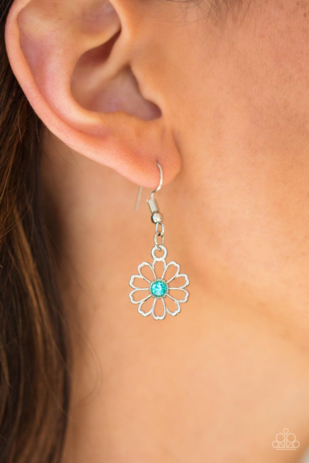 Paparazzi Accessories Daffodil Garden - Blue Stenciled silver floral charms link below the collar. Glittery blue rhinestones dot the floral centers, adding a whimsical finish to the airy palette. Features an adjustable clasp closure. Sold as one individua