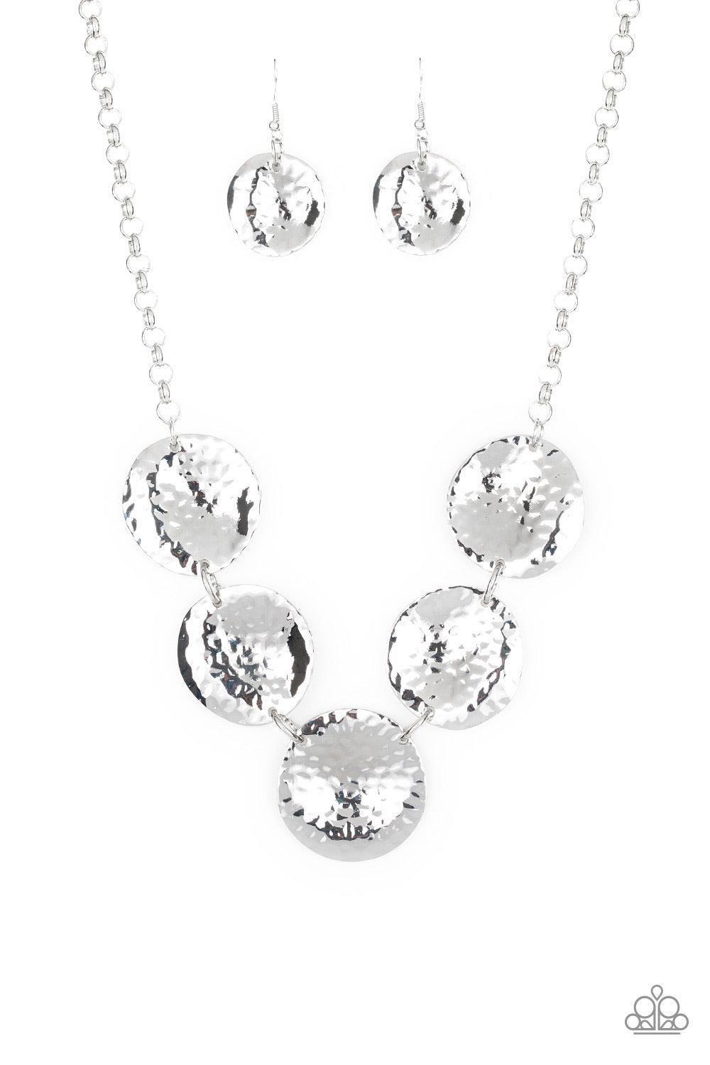 Paparazzi Accessories First Impressions - Silver Featuring a hammered high-sheen finish, imperfect round silver frames link below the collar for a casual look. Features an adjustable clasp closure. Sold as one individual necklace. Includes one pair of mat