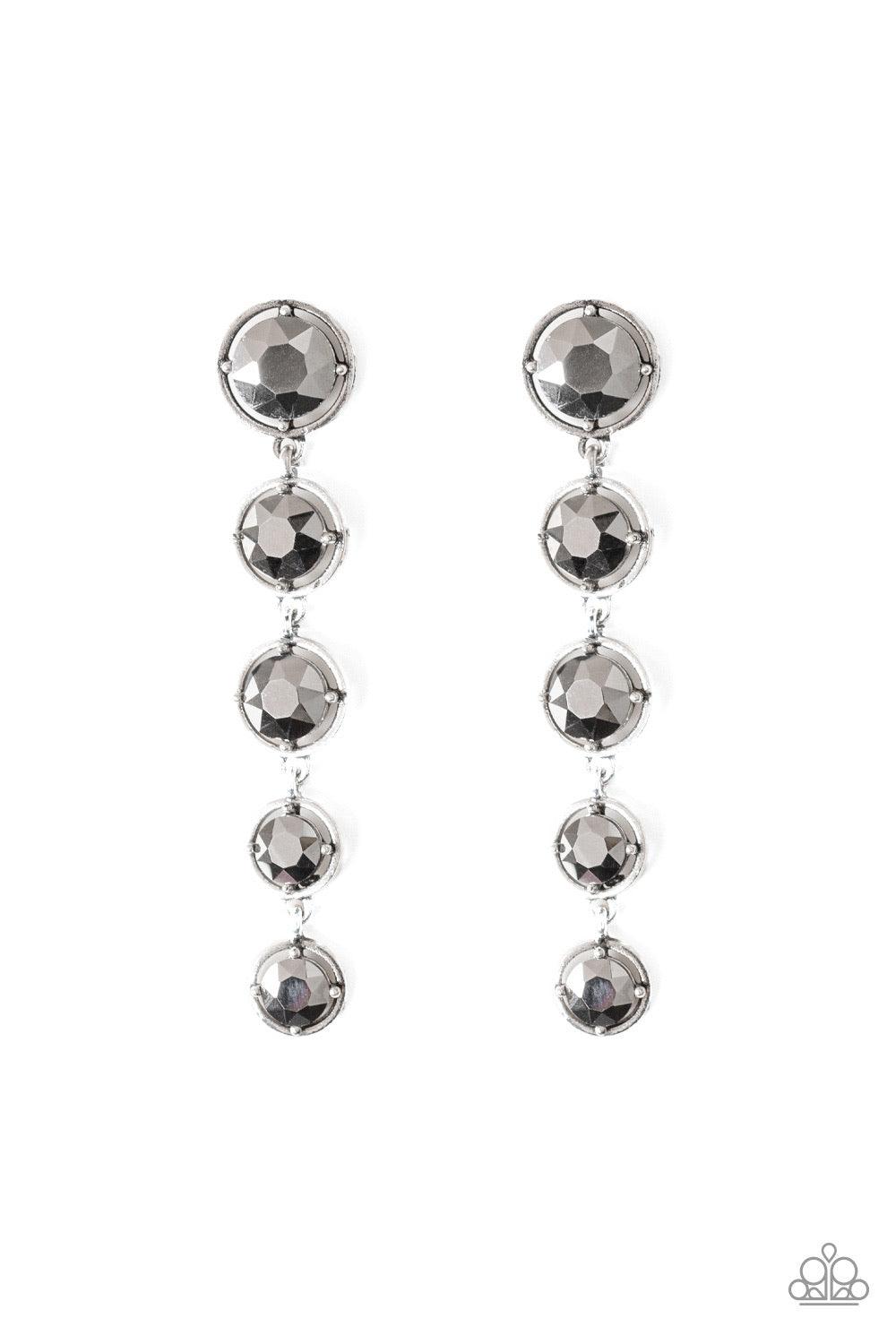 Paparazzi Accessories Dripping In Starlight - Silver Featuring sleek silver fittings, faceted hematite gems gradually decrease as they trickle from the ear for a glamorous look. Earring attaches to a standard post fitting. Jewelry