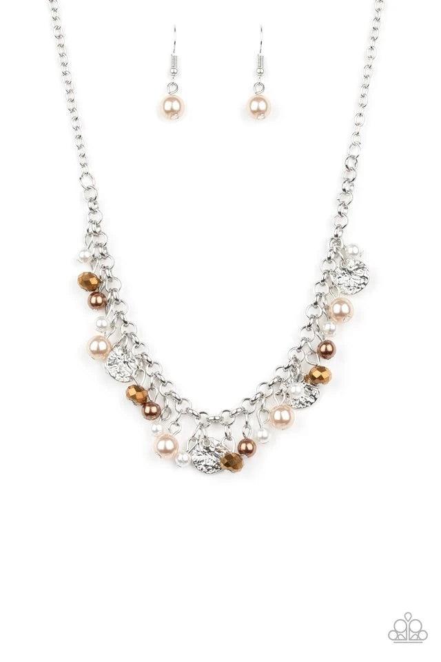 Paparazzi Accessories Coastal Cache - Mutli Pearly white and brown beads, aurum crystal-like gems, and hammered silver discs swing from a bold silver chain, creating a refined fringe below the collar. Features an adjustable clasp closure. Sold as one indi