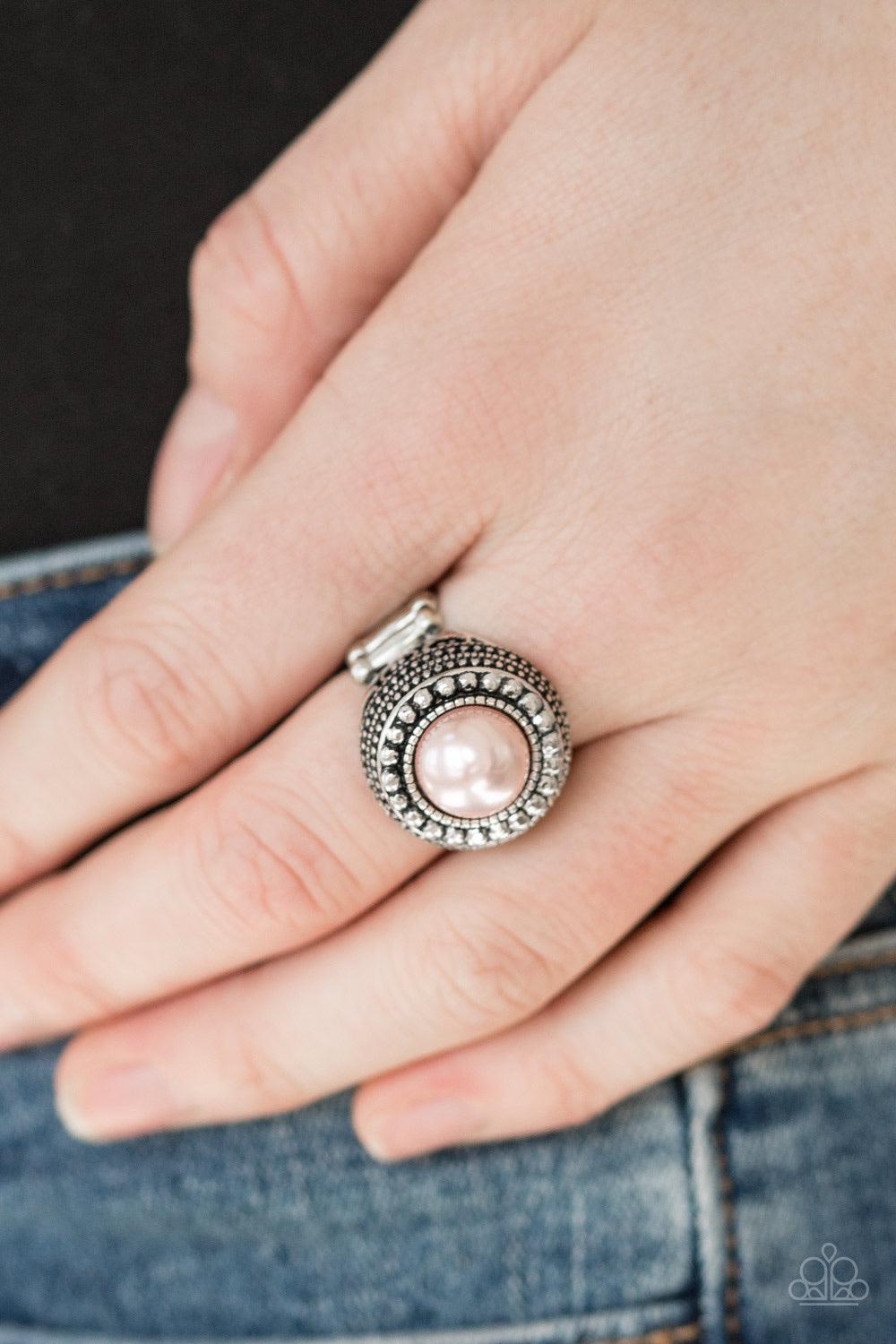 Paparazzi Accessories Bronx Beauty - Pink A classic pink pearl is pressed into the center of a stacked silver frame. Infused with classic silver studs and filigree detail, faceted silver studs spin around the pearly center, adding edgy shimmer to the dram