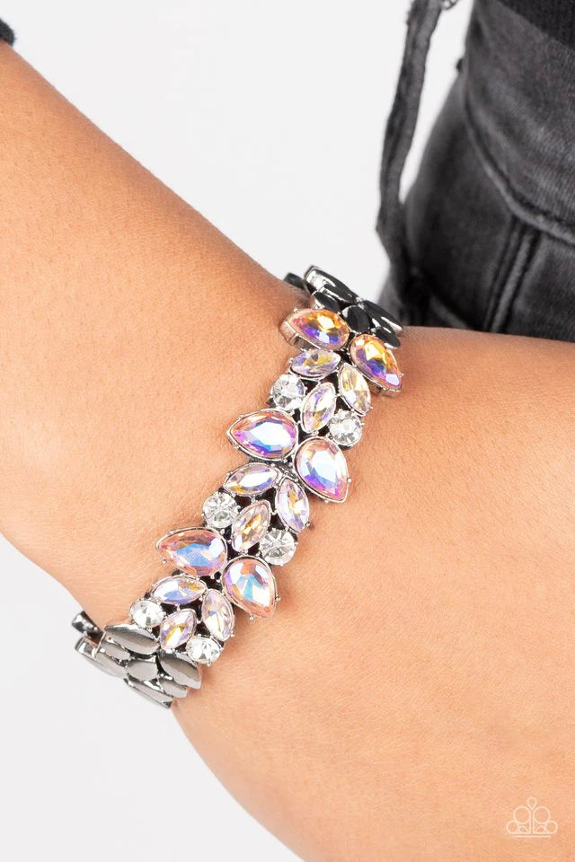 Paparazzi Accessories Glacial Gleam - Orange Iridescent coral teardrop and iridescent peach marquise gems converge with classic white rhinestones to create a subtle floral motif across the front of a silver cuff. The prismatic accents add an air of myster